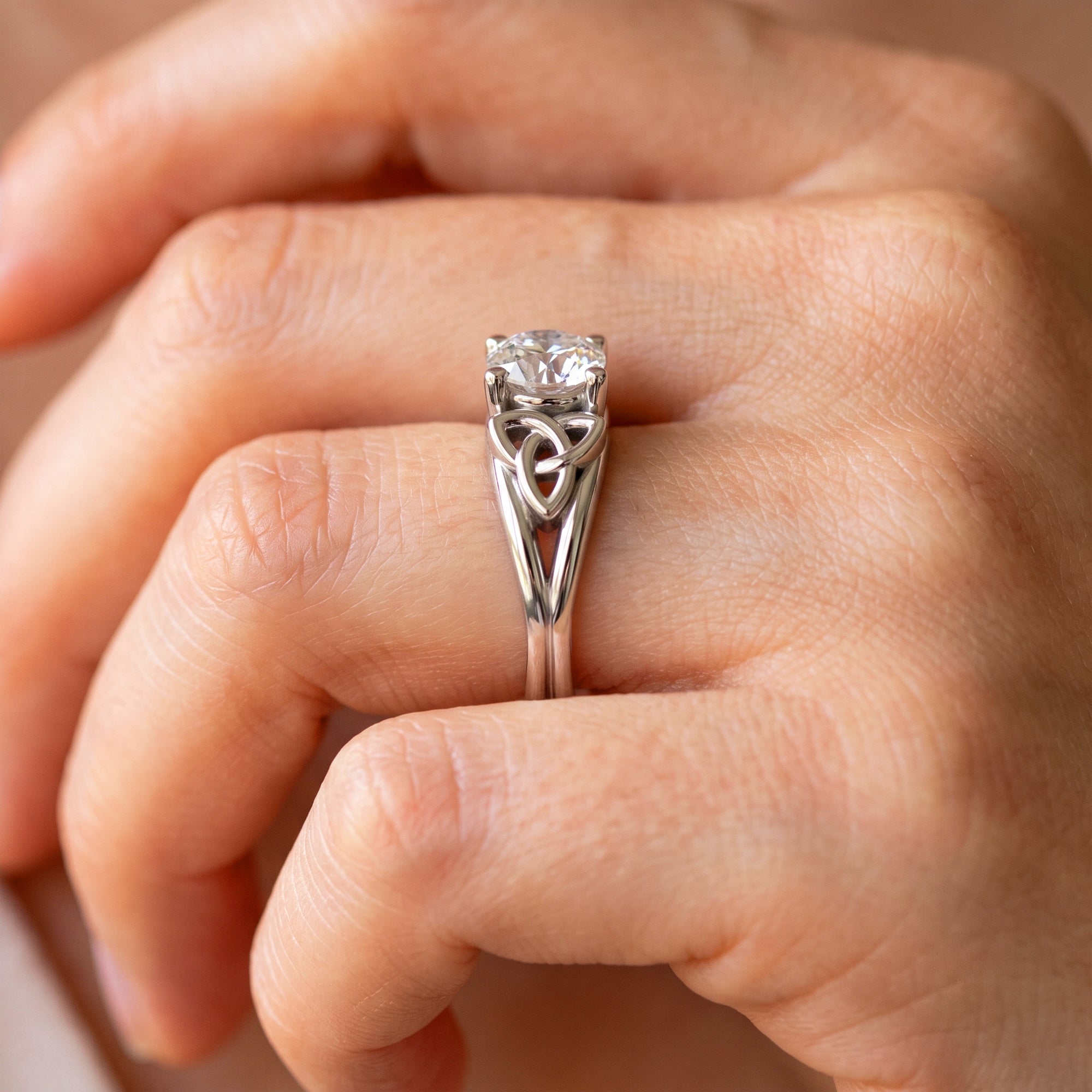 side view of Dainty Celtic Engagement on hand