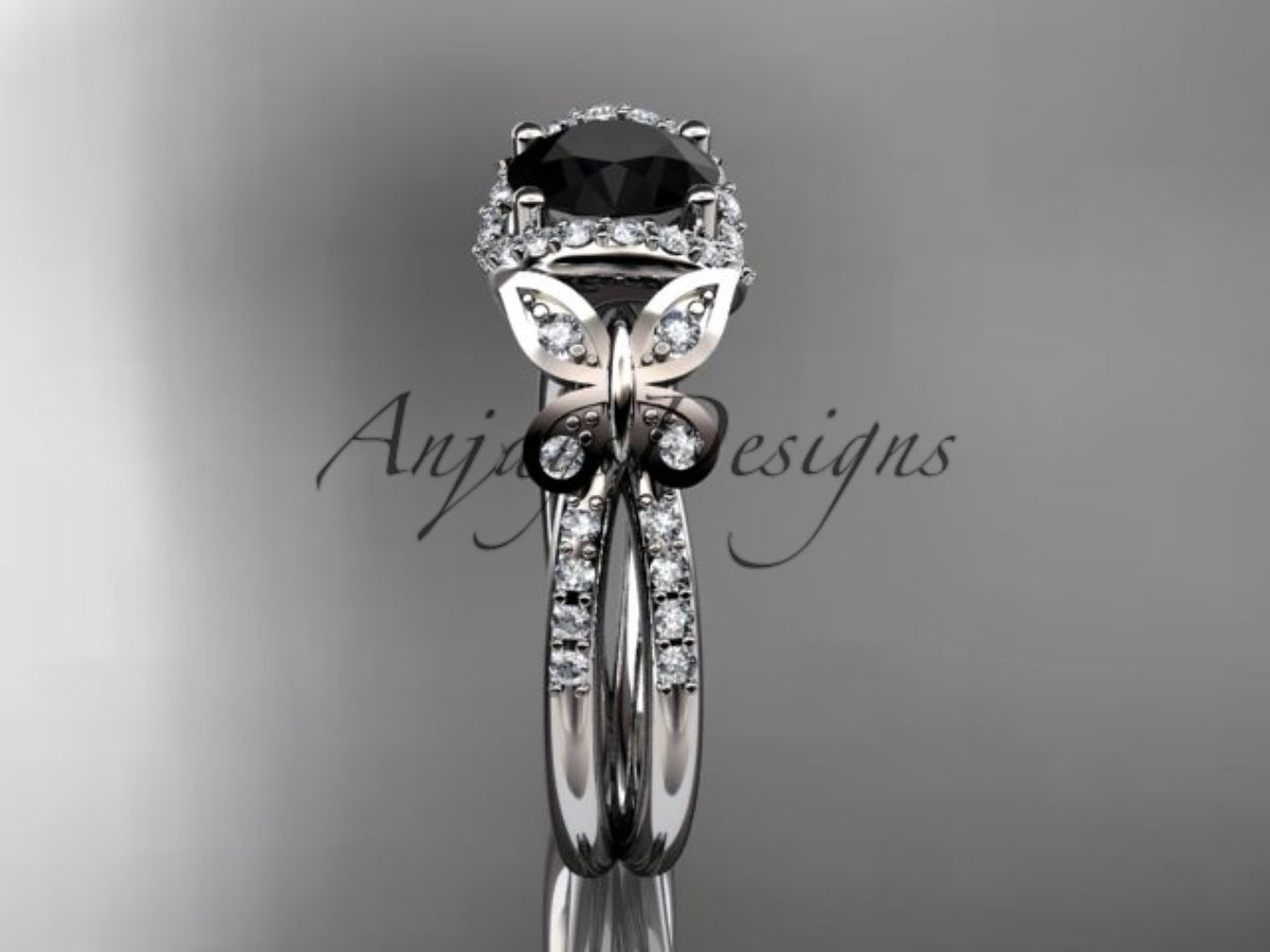 Black diamond center stone in a sculpted white gold butterfly setting