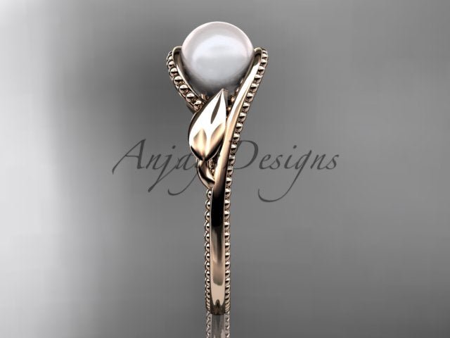 Close-up detail of 7.0mm white cultured pearl paired with a smooth carved rose gold leaf accent