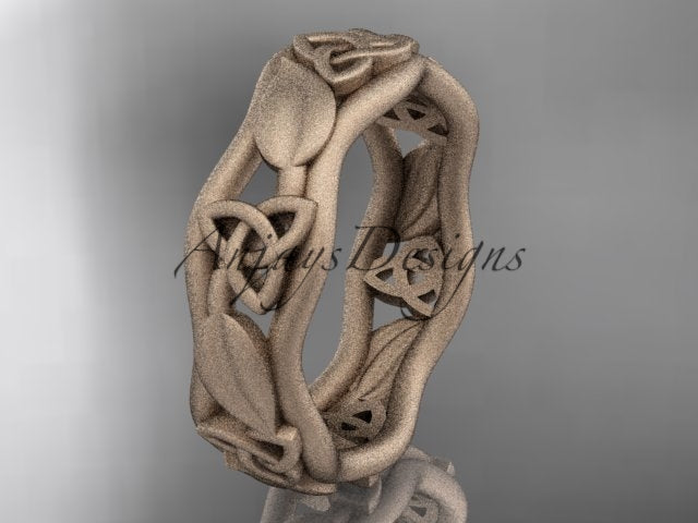 Rose gold Celtic wedding band, style CT7105B. Three-quarter view showcasing a slender, wavy branch band detailed with openwork trinity knots and smoothly sculpted organic leaf motifs.