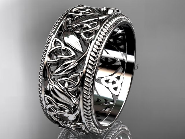 Platinum wide Celtic wedding band, style CT7508P. Three-quarter view displaying a heavy white platinum band featuring detailed openwork triquetra knots and nature-inspired leaf motifs with patterned borders.