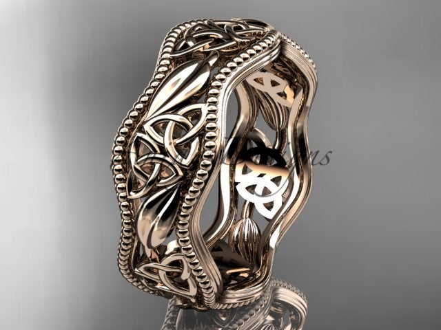 Rose gold Celtic wedding band, style CT7508P. Three-quarter view showcasing a scalloped milgrain edge band detailed with openwork Celtic trinity knots and polished leaf motifs.