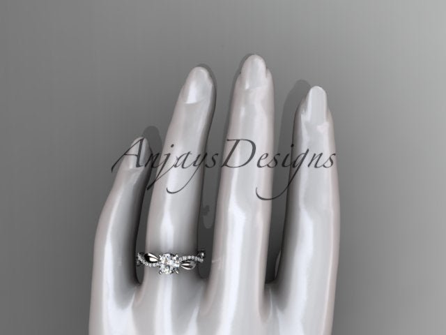 Close up of nature inspired leaf ring with round D VS1 lab grown diamond in 14k white gold