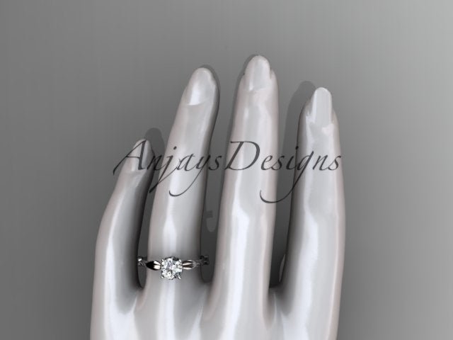 Close up of nature inspired leaf vine engagement ring with round lab grown diamond in 14k yellow gold