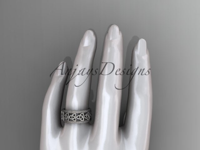 Platinum Celtic wedding band shown on a jewelry display hand