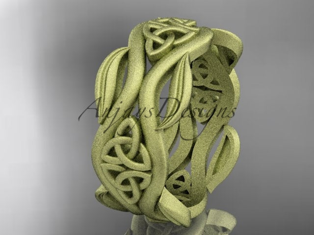 14K yellow gold matte Celtic trinity knot wedding band with flowing leaf details, shown at an angle.