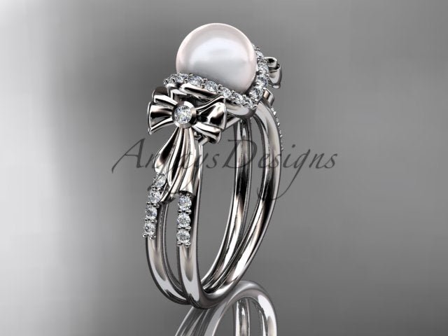Close-up view of 7.0mm smooth cultured pearl centered above a pave lab grown diamond bow motif   