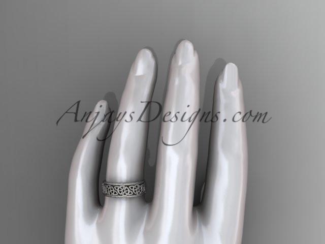 Close-up macro detail of intricate Celtic trinity knot texture and matte finish on 14K white gold band CT7163G