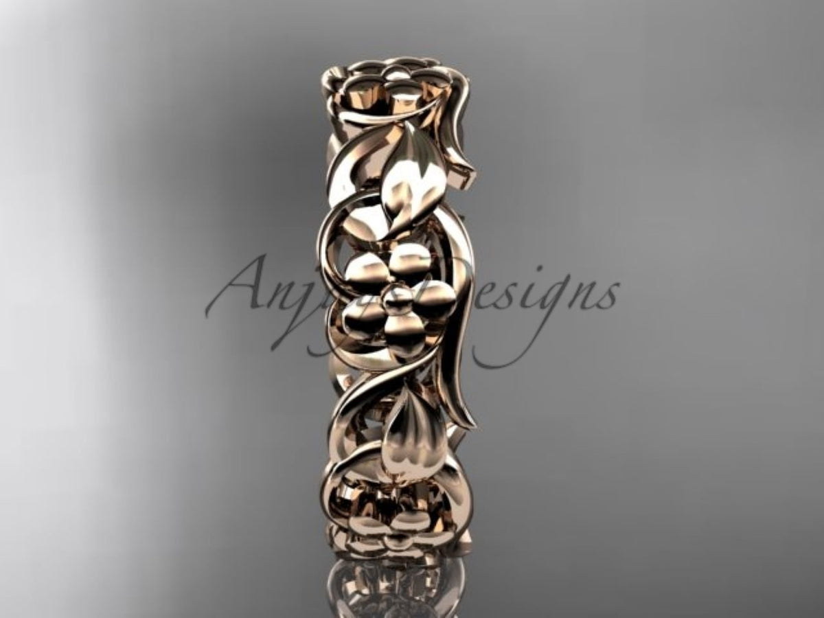 • Rose gold floral wedding band, style ADLR537G. Stood upright vertically, emphasizing the warm tone of the metal across the leaf pattern.
